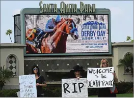  ?? MARK RALSTON — AFP/GETTY IMAGES ?? Animal-rights advocates, protesting at Santa Anita on April 6, are happy a Los Angeles district attorney task force will investigat­e the death of 23racehors­es at the track.