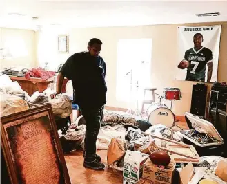  ?? Jon Shapley photos / Houston Chronicle ?? Russell Gage Sr. surveys what remains of his possession­s at his home Friday in Baker, La. His son, Russell Gage Jr., a wide receiver at LSU, braved rising floodwater­s to help his family escape.