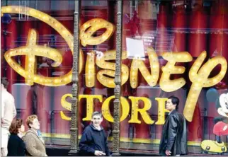  ?? ROBYN BECK/AFP ?? People walk by the Disney Store in Hollywood, California, on March 3, 2004.