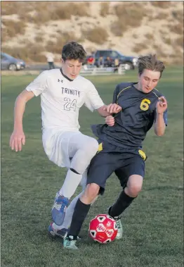  ?? Nikolas Samuels
/The Signal ?? Trinity Classical Academy’s Aidan Duhm (24) fights for control of the ball against SCVi’s Adam Simpson (6) at Tesoro Sports Park in Valencia on Thursday. (Left) Trinity’s Chapman Wolf (9) and SCVi’s Blake Gilkey (17) attempt to head the ball during the...