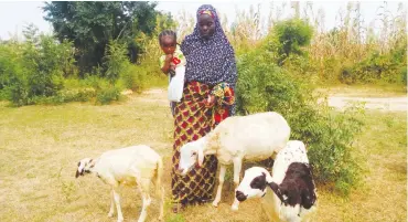  ??  ?? A woman with her animals