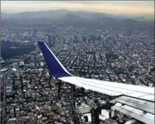  ??  ?? The view from the plane when descending into Mexico City gives a glimpse not only of how big the city is and its towering skyscraper­s, but also of some of the mountains that surround the bustling metropolis.