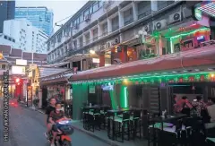  ??  ?? NEEDS SHOT IN ARM: Unlike entertainm­ent venues on Silom Road, those on Patpong Road, once a centre of Bangkok’s night life, is still quiet as they have lost their main customers who are foreign tourists.