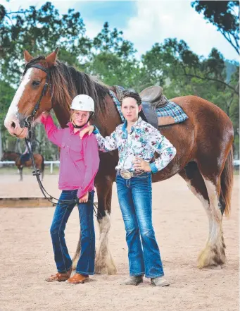  ?? STANDING UP: Zahara Malpas, 11, of Black River, and Demi Kelly, 11, of Charters Towers, with Mary the Clydesdale at the rally to save the Bluewater equestrian centre. Picture: ZAK SIMMONDS ??