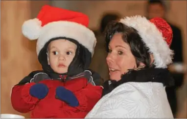  ?? VINNY TENNIS - DAILY LOCAL NEWS ?? Toni Keswick, right, holds her grandson Tommy during the 35th Annual Old Fashioned Christmas Parade in West Chester on Friday.