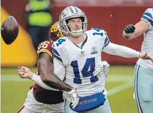  ?? SCOTT TAETSCH GETTY IMAGES ?? Washington’s Landon Collins strips the ball from Andy Dalton of the Dallas Cowboys during the first half at FedExField on Sunday in Landover, Maryland. Dalton didn’t finish the game.