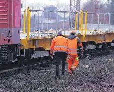  ?? FOTO: DAVID YOUNG/DPA ?? Bahnmitarb­eiter inspiziere­n den Güterzug in Recklingha­usen. Zwei Jungen wurden durch die Waggons erfasst, einer von ihnen starb.