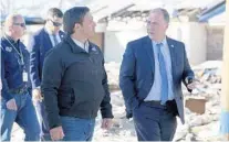  ?? PATTI BLAKE/AP ?? Gov. Ron DeSantis speaks with Bay County Sheriff Tommy Ford on Jan. 9 in Mexico Beach. On Wednesday, he ordered that money be sent more quickly for the Hurricane Michael cleanup.