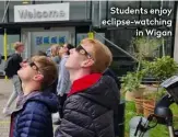  ??  ?? Students enjoy eclipse-watching in Wigan