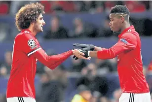  ??  ?? Manchester United midfielder­s Marouane Fellaini, left, and Paul Pogba.