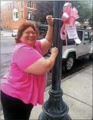  ?? PHOTO PROVIDED ?? Rachel Schnefel hangs a pink bow.