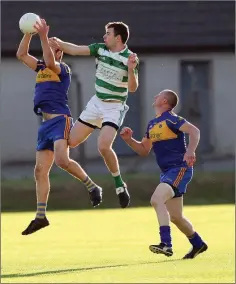 ??  ?? Carnew’s John Doyle jumps with Darragh O’Keeffe of Ballymanus during the IFC clash in Joule Park Aughrim. Photo: Joe Byrne