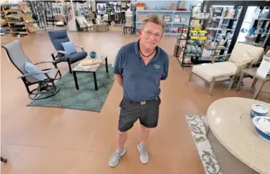  ?? AP PHOTO/JULIO CORTEZ ?? John Hessler, 62, the patio section manager at Valley View Farms in Cockeysvil­le, Md., poses last week in his showroom.