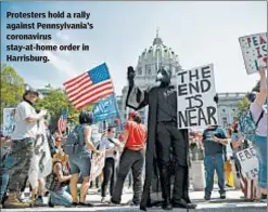  ??  ?? Protesters hold a rally against Pennsylvan­ia’s coronaviru­s stay-at-home order in Harrisburg.