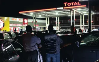  ?? TSVANGIRAI MUKWAZHI AP ?? MOTORISTS await their turn to be served at a fuel queue in the Zimbabwean capital Harare. President Emmerson Mnangagwa has more than doubled the price of fuel, hoping the increase would end severe shortages that are fuelling public anger. |