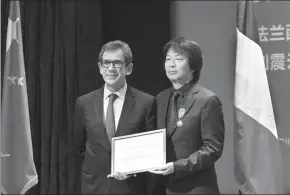  ?? PHOTOS PROVIDED TO CHINA DAILY ?? Chinese writer Liu Zhenyun (right, pictured on top) poses with French ambassador to China Jean-Maurice Ripert after receiving a medal of Knight of the Order of Arts and Letters in Beijing on April 13.