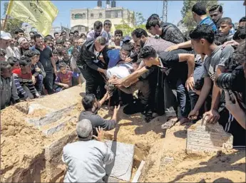  ?? Photograph­s by Marcus Yam Los Angeles Times ?? A CROWD gathers for the burial of Jamal Afaneh, 15, who was shot in Friday’s protest at the GazaIsrael border. At least 49 protesters have been killed by Israeli soldiers since March 30, Gaza officials say.