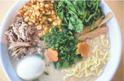  ?? PHOTOS BY MARK HENLE/THE REPUBLIC ?? Roasted pork, spicy kernels of corn and a soft-boiled egg add protein and substance to paitan ramen at Umami in Tempe.