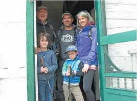  ?? CITIZEN PHOTO BY CHRISTINE HINZMANN ?? Jeremy Bignell, from Britain, left, visited Huble Homestead with his family who live in Prince George, including son-in-law Matt Racicot, daughter Sarah, and grandsons Luke, 8 and Owen, 5. Despite the rain the family enjoyed their time exploring the site on Sunday during the annual Potato Festival.