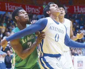  ?? JOEY MENDOZA ?? Ateneo’s Thirdy Ravena and La Salle’s Mark Dyke jockey for position in a rebound play during their Filoil Flying V Preseason Cup showdown Sunday. The Eagles subdued the Archers in overtime, 81-75.