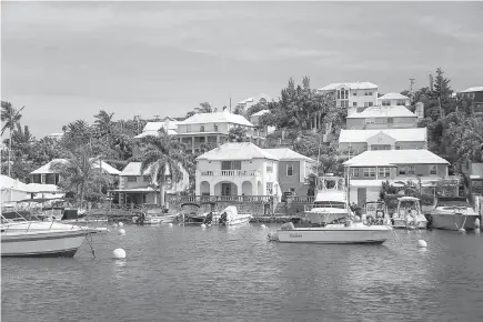  ?? Bermuda Tourism Authority/TNS ?? ABOVE: Bermuda’s Flatts Inlet, where luminous turquoise waters lap shell-pink sand beaches, frangipani perfumes the air, and pastel colored houses snuggle behind winding hedgerow-bordered roads.