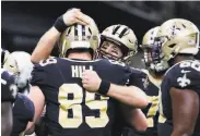  ?? Butch Dill / Associated Press ?? New Orleans’ Drew Brees celebrates his TD pass to tight end Josh Hill, which broke an NFL record.