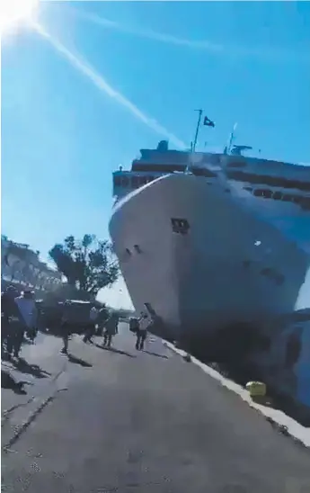  ??  ?? A photo taken from social media video grabs of the cruise ship liner as it was coming into dock, hitting the wharf and crashing into a tourist boat (pictured below).