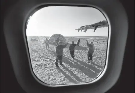  ??  ?? Guardians from left, Brandon Qirqqut, Mark Ullikataq and Jimmy Pauloosie Jr. wave goodbye to a plane as it leaves Davit camp on Saunitalik Island near Gjoa Haven, Nunavut, in early September. Guardians protect the area as crews work to recover...