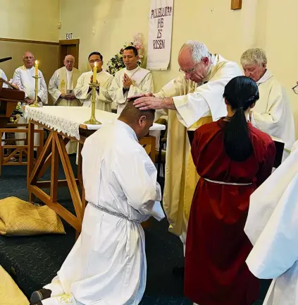  ?? PHOTOS: SUPPLIED ?? Celebratio­n . . . Catholic Bishop of Dunedin Michael Dooley ordains Iosefa Setu (kneeling), of Balclutha, as a permanent deacon during a recent ceremony at St Mary McKillop Church, Balclutha. Right: Fania TaaviliSet­u (left), Catholic Bishop of Dunedin Michael Dooley and Deacon Iosefa Setu.