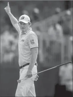  ?? The Associated Press ?? MR. 59: Brandt Snedeker raises his arm after sinking an eagle putt on the 15th hole during the second round of the Wyndham Championsh­ip Friday in Greensboro, N.C. Play was suspended on Saturday due to severe weather.