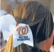  ??  ?? Washington’s cheerleade­rs wore bows in their hair in support of the team on Saturday.