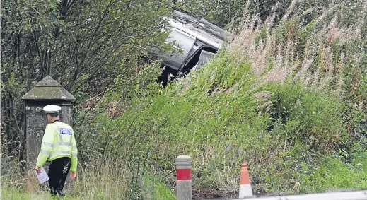  ??  ?? Police at the scene of the fatal accident on the A90 just north of Forfar, which claimed the life of a man in his 20s.