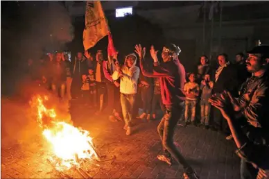  ?? The Associated Press ?? Palestinia­ns at the main square in Gaza City burn tires during a protest Thursday against U.S. President Donald Trump’s decision to recognize Jerusalem as the capital of Israel.