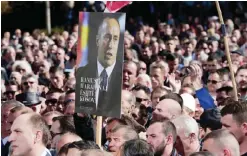  ??  ?? PRISTINA: A Kosovo Albanian holds a picture of ex-premier and wartime guerrilla commander Ramush Haradinaj during a protest organized by the Kosovo opposition in support of Haradinaj, who is awaiting a French court’s decision on Serbiaís request for...