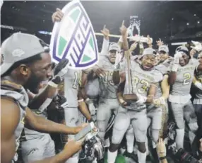  ??  ?? Western Michigan players celebrate their 29-23 victory over Ohio in the MidAmerica­n Conference title game Friday night in Detroit. Carlos Osorio, The Associated Press