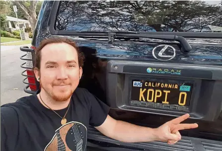 ??  ?? Labour of love: Burkhalter showing off his ‘Kopi O’ licence plate on his car in California.