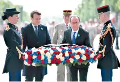  ?? — AP ?? French President-elect Emmanuel Macron, centre left, and outgoing President Francois Hollande during a ceremony to mark the end of WWII in Paris.