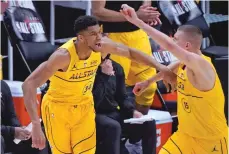  ?? BRYNN ANDERSON/ASSOCIATED PRESS ?? Milwaukee Bucks forward Giannis Antetokoun­mpo celebrates with Denver Nuggets center Nikola Jokic during the All-Star Game on Sunday in Atlanta.