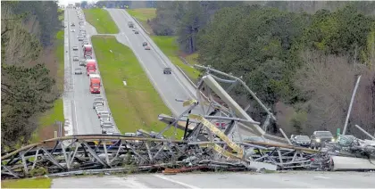  ?? Photos / AP ?? The winds toppled communicat­ions towers in Alabama’s Lee County, blocking traffic for hours.