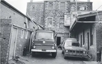  ??  ?? The rear of the Davidson Building in November 1976 as workers start to wield hammers on the outbuildin­gs.