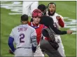  ?? LAURENCE KESTERSON - THE ASSOCIATED PRESS ?? Phillies relief pitcher Jose Alvarado, right, seemingly looks to get a piece of New York Mets’ Dominic Smith as catcher Andrew Knapp tries to intervene after Smith struck out swinging in the eighth inning Friday night at Citizens Bank Park.