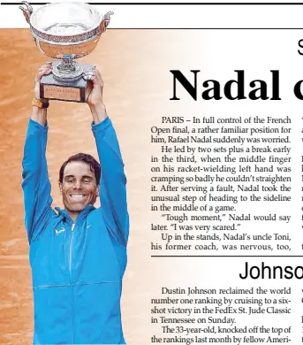  ?? AFP ?? Spain’s Rafael Nadal hoists his 11th French Open trophy after defeating Austria’s Dominic Thiem in straight sets.