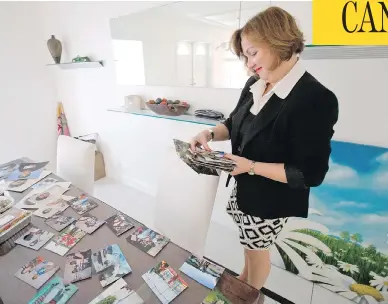  ?? WILFREDO LEE / THE CANADIAN PRESS / AP ?? Canadian diplomat Roxanne Dube looks through old photos of her children during an interview in Miami in February. Her younger son is back in Canada after making a plea deal in a double-murder case.