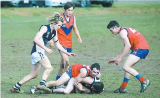  ??  ?? Left: Buln Buln’s Simon Dawson wraps up Nar Nar Goon opponent Richard Manley.
Nar Nar Goon’s Bailey Beck and Buln Buln’s Shaun Beecroft wait for the ball to come out