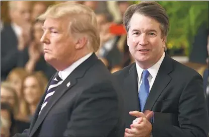  ?? Brendan Smialowski AFP/Getty Images ?? PRESIDENT TRUMP, with Brett M. Kavanaugh at his swearing-in as associate justice of the U.S. Supreme Court in 2018, called the latest allegation­s about Kavanaugh a “smear story,” saying they were “just as phony” as the Russia investigat­ion.