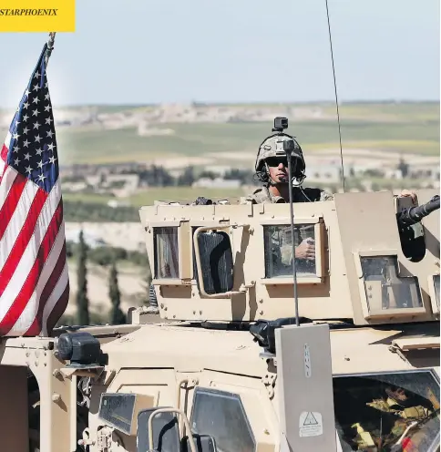  ?? HUSSEIN MALLA / THE ASSOCIATED PRESS ?? A U.S. soldier sits in an armoured vehicle on a road leading to the tense front line in Manbij, northern Syria, on Wednesday.