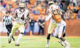  ?? BRETT CARLSEN/GETTY IMAGES ?? Dalvin Cook, left, carries the ball against Syracuse in a November game. The NFL prospect says he will not sit out Florida State’s bowl game against Michigan Dec. 30.