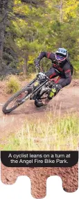  ??  ?? A cyclist leans on a turn at the Angel Fire Bike Park.