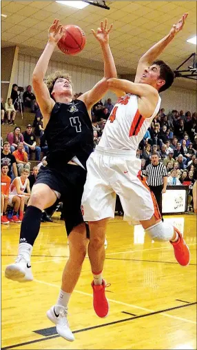  ?? WESTSIDE EAGLE OBSERVER/Randy Moll ?? Gravette’s Chris Childress (right) blocks a shot attempt by Asa Hutchinson IV of Bentonvill­e and fouls Hutchinson during nonconfere­nce play between Bentonvill­e and Gravette at the Lion Field House in Gravette on Nov. 21.