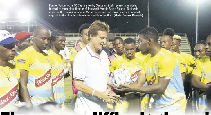  ?? (Photo: Dwayne Richards) ?? Former Waterhouse FC Captain Keithy Simpson, (right) presents a signed football to managing director of Tankweld Metals Bruce Bicknel. Tankweld is one of the main sponsors of Waterhouse and has maintained its financial support to the club despite one year without football.